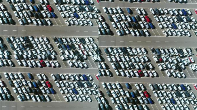 在倾斜的停车位中，停放在停车场中的大量汽车上方的鸟瞰图。4K