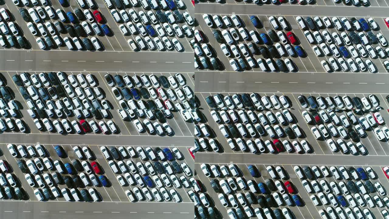 在倾斜的停车位中，停放在停车场中的大量汽车上方的鸟瞰图。4K