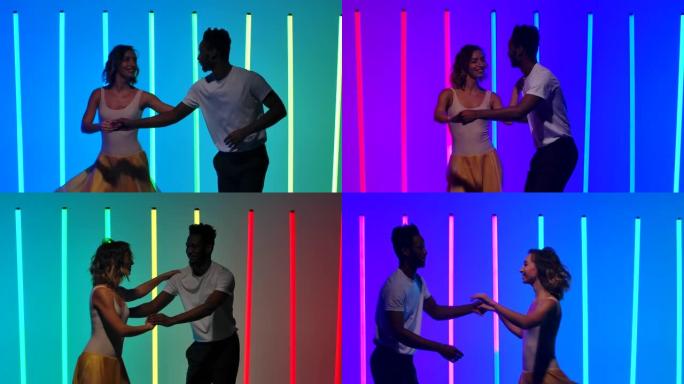 快乐的黑人和白人女人在五彩霓虹灯的背景下练习条纹和旋转。热情的拉丁美洲萨尔萨舞慢动作。特写