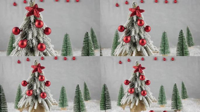 圣诞装饰品背景。绿树上装饰着红色的球。