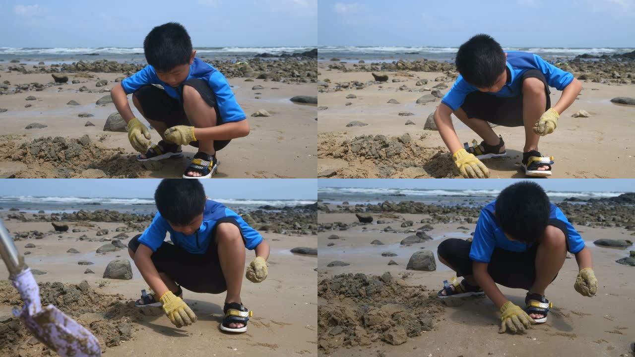 年轻的海滩拾荒者玩沙子沙滩海滩