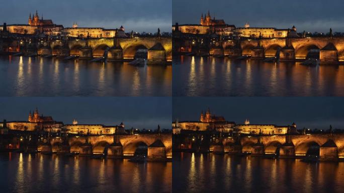 捷克共和国布拉格的一条流动的伏尔塔瓦河和一座石制查理大桥的延时视图，以及路灯和夜间鸭子表面的光线