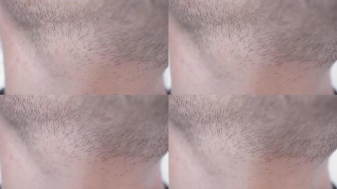 人脸上的头发特写。头发生长的男人的脖子和胡须。脖子上的脉搏和心跳。