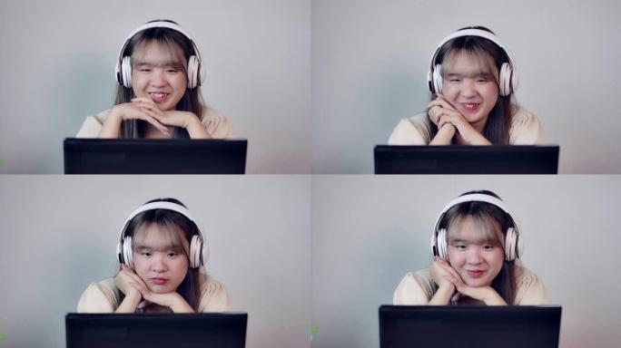 一个亚洲少年女孩在学习休息期间听音乐，看电影和与朋友聊天，并在客厅检疫