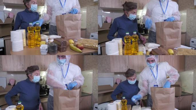 在新型冠状病毒肺炎冠状病毒流行期间，身穿细菌防护服和防护口罩的男子向检疫的老年人运送食物。捐赠箱，里