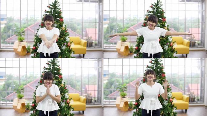 聋哑女孩使用手势欢迎圣诞树背景