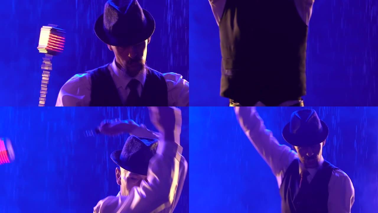 时髦的男人用发光的手榴弹表演火术。艺术家在蓝色烟熏工作室背景下的雨水中表演。展示光线和水。慢动作特写