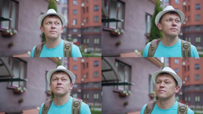 一名戴着白帽子的男性游客的肖像，在城市中漫步，相机跟踪