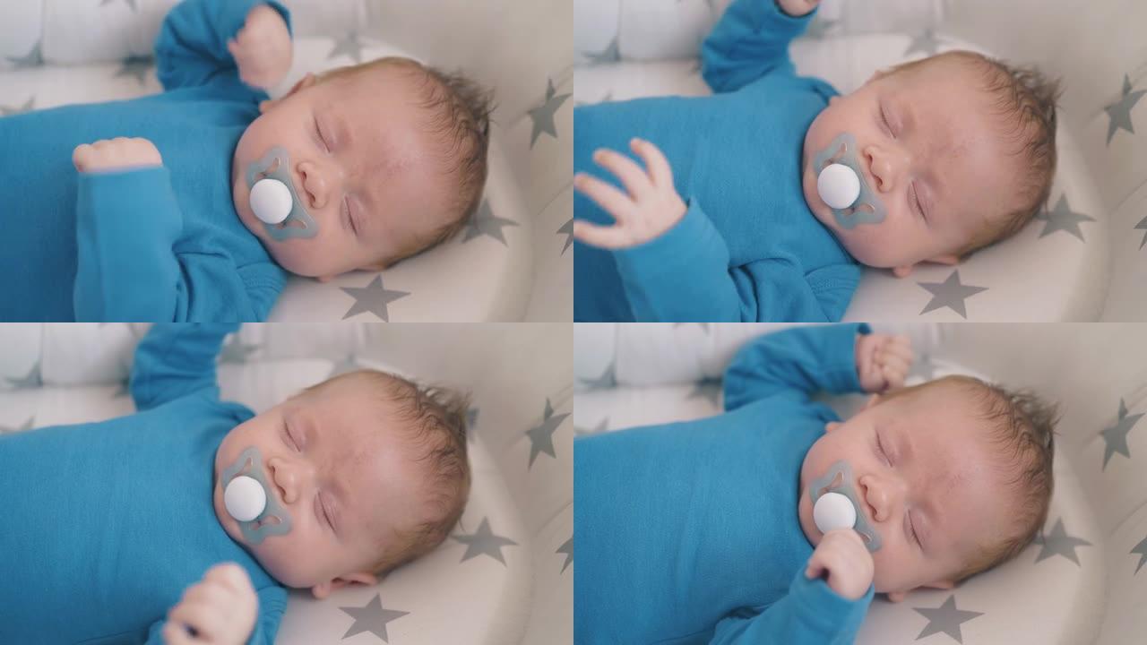 新生婴儿挥舞双手睡在家里的茧特写
