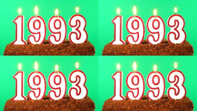 蛋糕与数字1993点燃的蜡烛。上个世纪的日期。色度键。绿屏。隔离