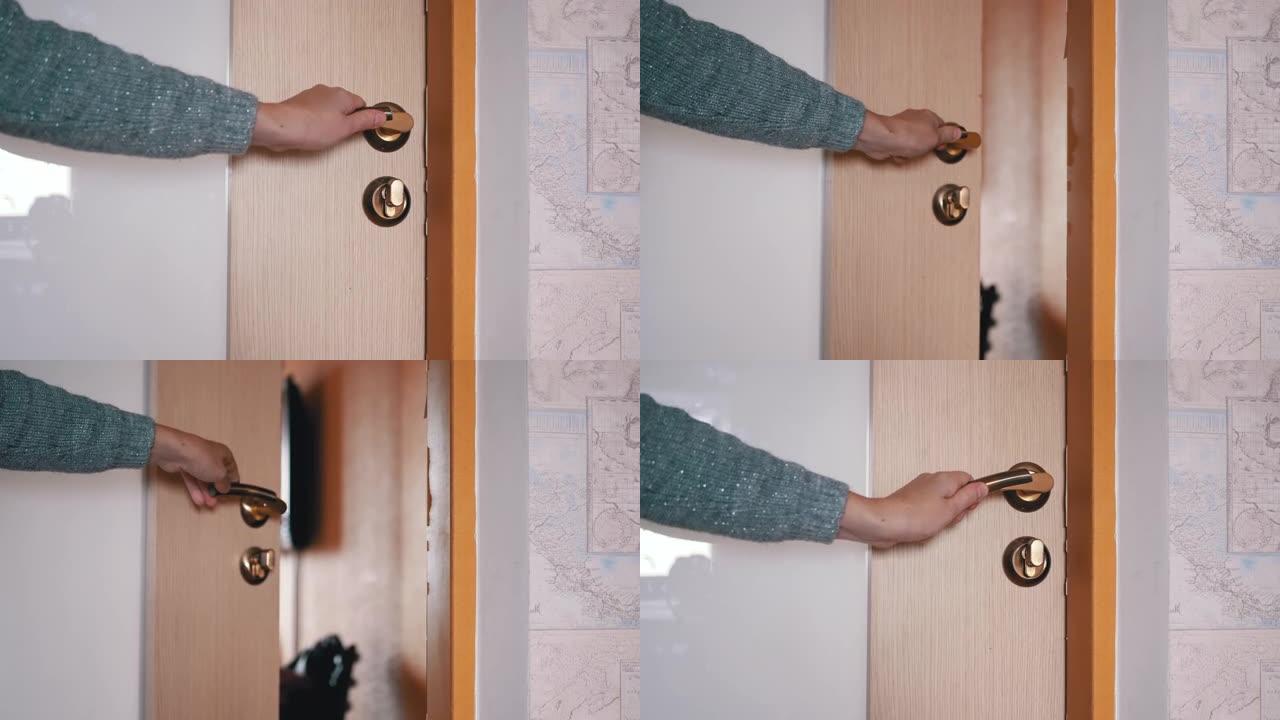 女性手使用门把手打开和关闭内门