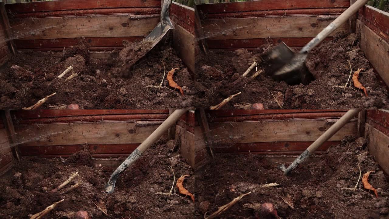 铲子特写在木箱中挖掘腐殖质。