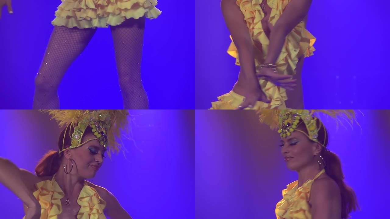 性感的年轻女子穿着巴西桑巴舞狂欢节服装，羽毛的黄色羽毛在蓝色灯光的背景下跳舞。慢动作特写