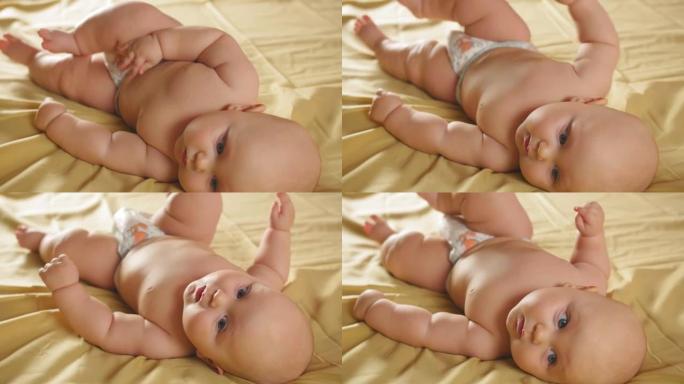一个胖乎乎的婴儿躺在它的侧面，试图在她的肚子上翻滚。特写镜头。
