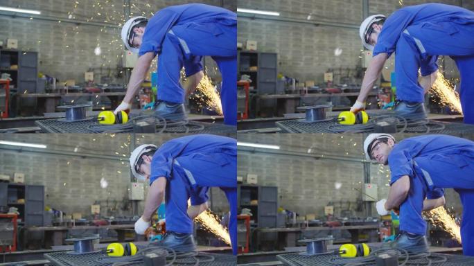 高加索男性工人穿着安全的制服耐磨焊工皮革，在钢结构上进行电动砂轮磨削的qc咀嚼和测量在车库中，橙色散