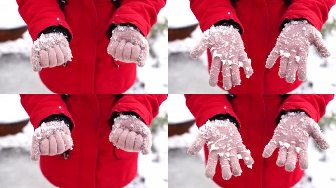 女人的手戴着雪的手套。冬天，无法辨认的女人在街上握着拳头