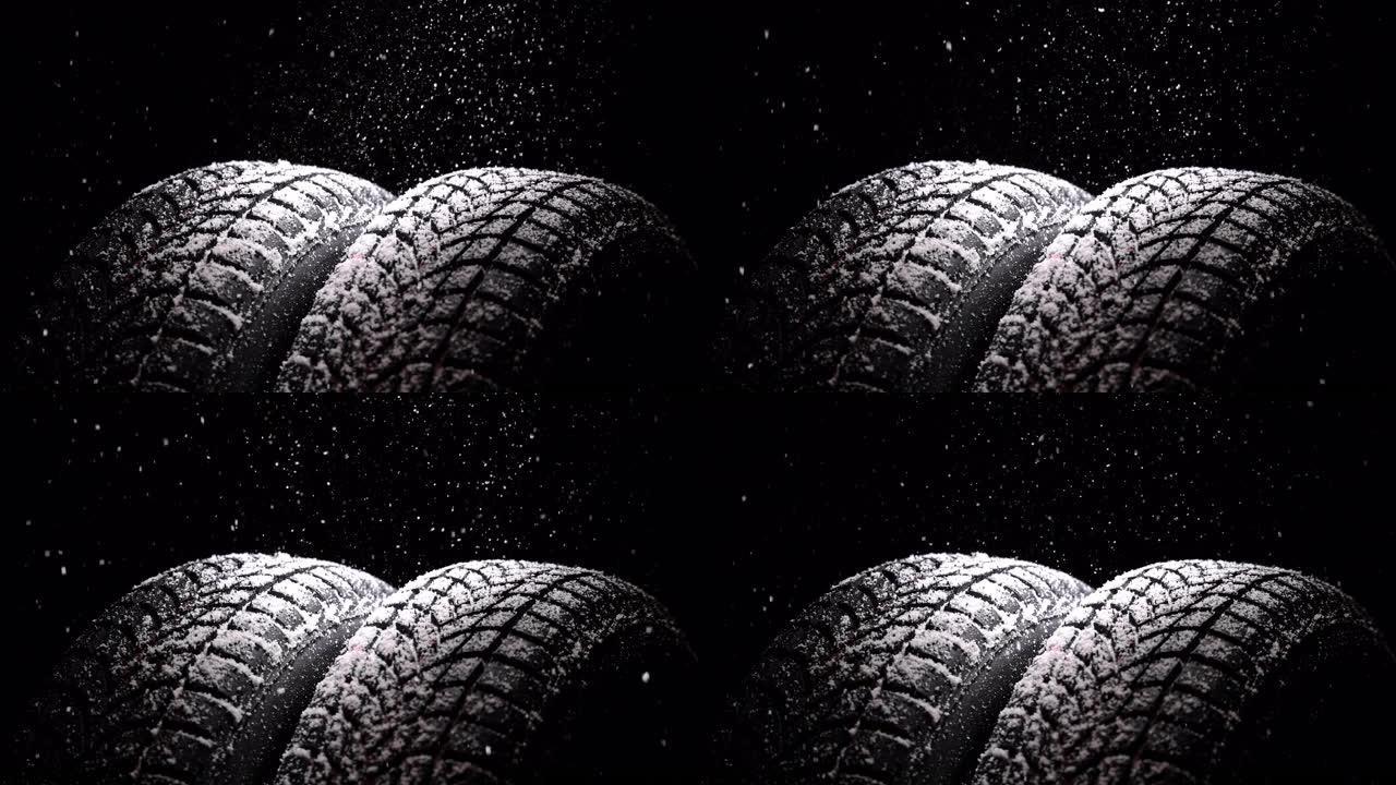 黑色背景上的冬季汽车轮胎和雪雨，4k慢动作视频