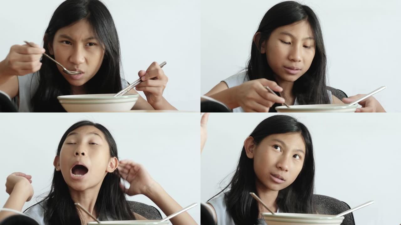 快乐的亚洲儿童在家一起在餐桌上吃方便面汤，生活方式理念。
