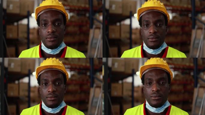快乐非洲工人男子在送货箱仓库内，戴着冠状病毒爆发的防护口罩