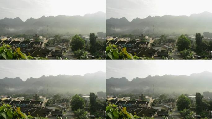 在日出的时候，从上面可以看到在自然和雾中居住的房子。美丽的风景下的山谷小镇。村庄早晨的宁静。