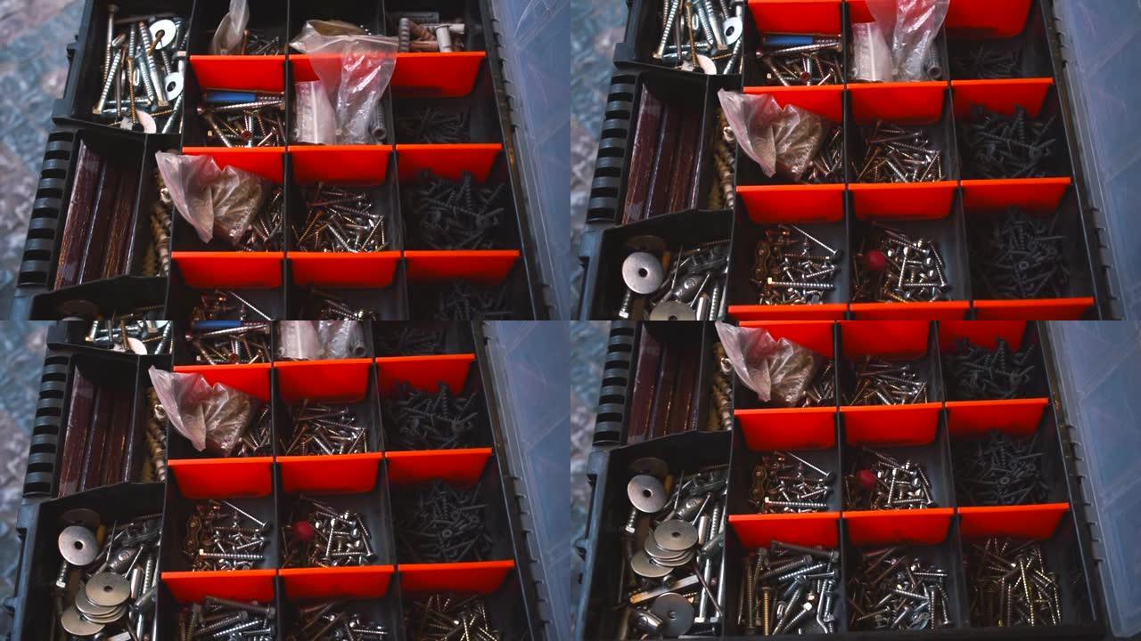 用木匠的工具打开盒子。钉子、螺钉、螺母和小金属物体。