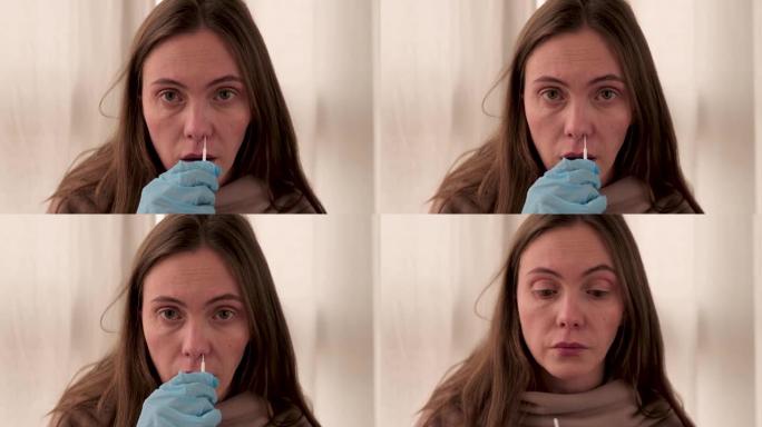 女人用医用卫生棉条从鼻粘膜取拭子