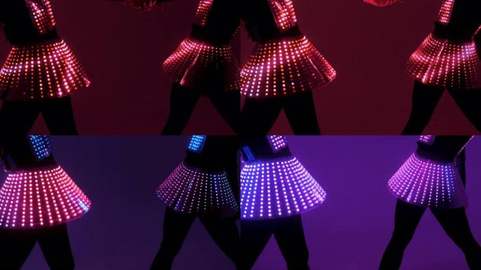 两名穿着紫外线服装的性感女迪斯科舞者