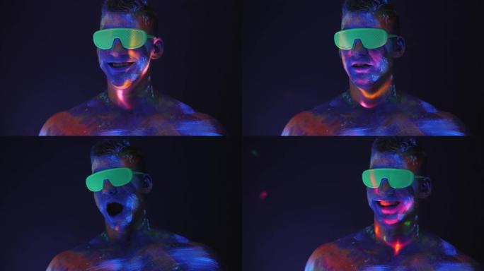 一个肌肉发达的男人的肖像，在黑暗中他的脸和身体上有紫外线图案。