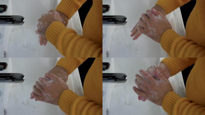 一名男子洗净手上的污垢，一名男子用水在水龙头下洗手，保持身体清洁。