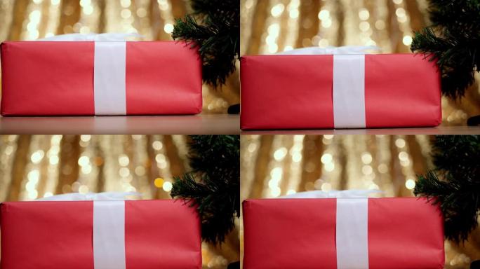 带有bokeh背景的圣诞树红色礼品盒。