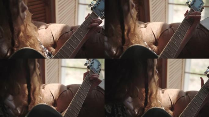 女孩演奏音乐，在吉他指板上挑选和弦，特写