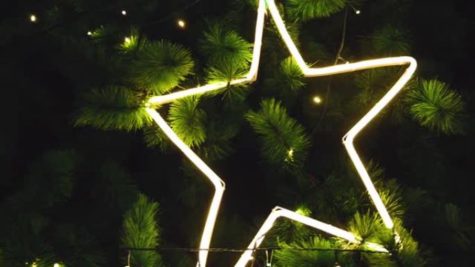 圣诞树上悬挂着闪亮的黄色星星和灯光的照明装饰。