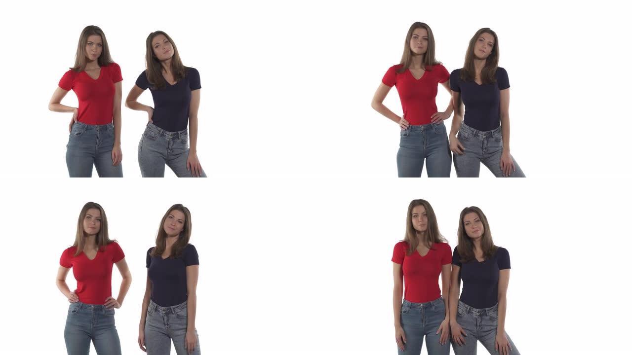 诱人的高加索双胞胎姐妹，穿着牛仔裤，红色和黑色t恤，手放在臀部摆姿势。孤立在白色背景上