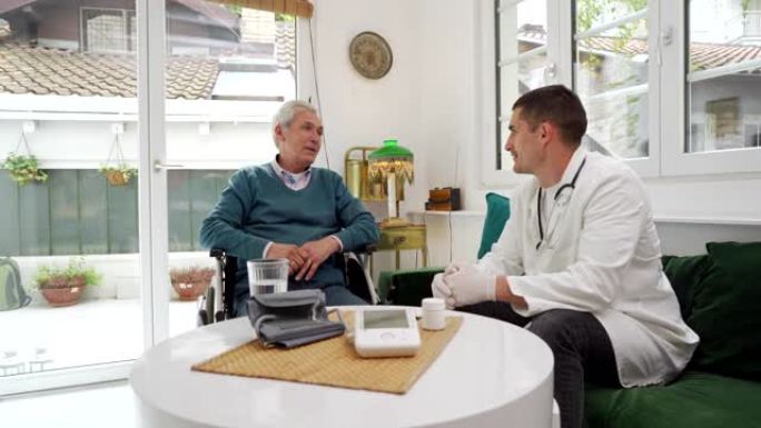 由于他的残疾，坐在轮椅上的老人在家中接受一位年轻医生的医疗建议