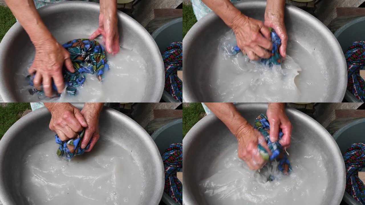 80岁妇女的皱纹手用受损的老年皮肤洗手洗衣