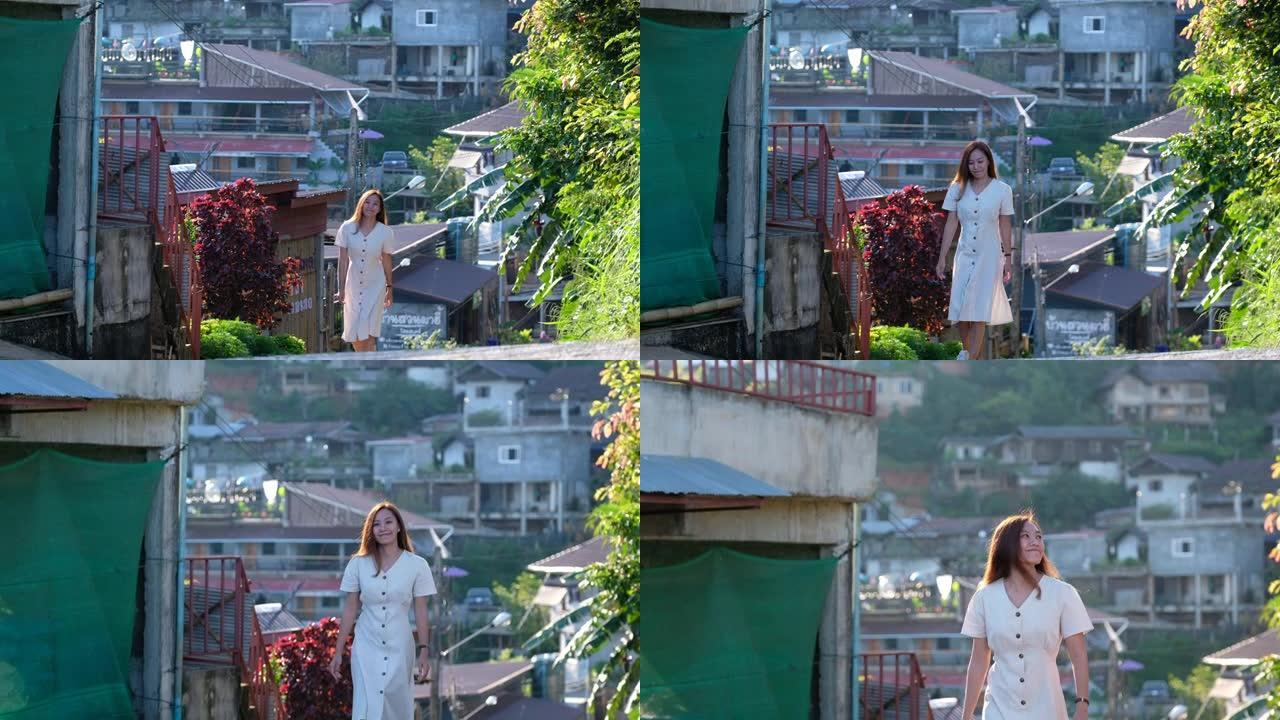 一位美丽的年轻亚洲妇女在乡村山村漫步