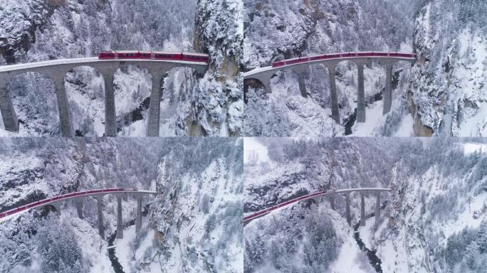 冬天有铁路和火车的Landwasser高架桥。下雪。瑞士阿尔卑斯山。瑞士。鸟瞰图。无人机向后和向上飞