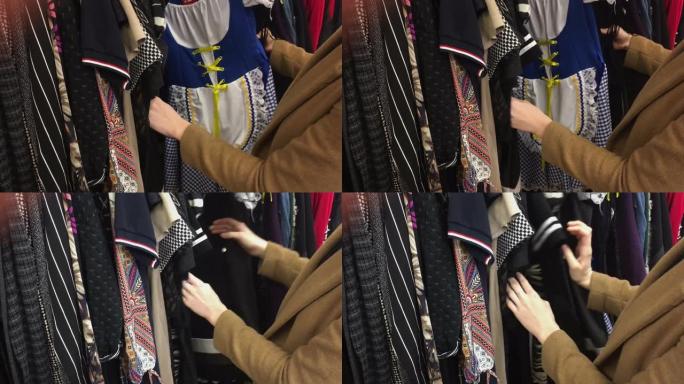 女人在旧货店里翻找二手衣服