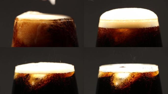 可乐汽水饮料在玻璃杯中加冰特写。灰色背景上的宏