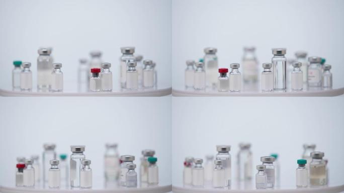 许多安瓿与新型冠状病毒肺炎冠状病毒疫苗。一瓶抗SARS疫苗-CoV-2病毒在白色背景实验室。全球危险