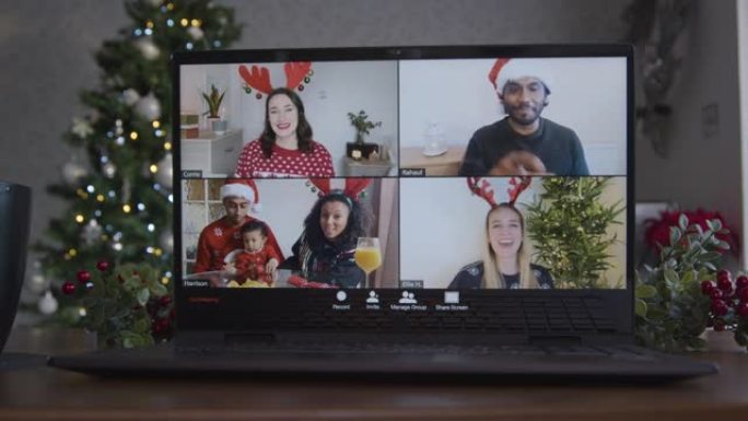 在朋友之间在笔记本电脑上滑动4向分屏圣诞主题视频通话的特写镜头