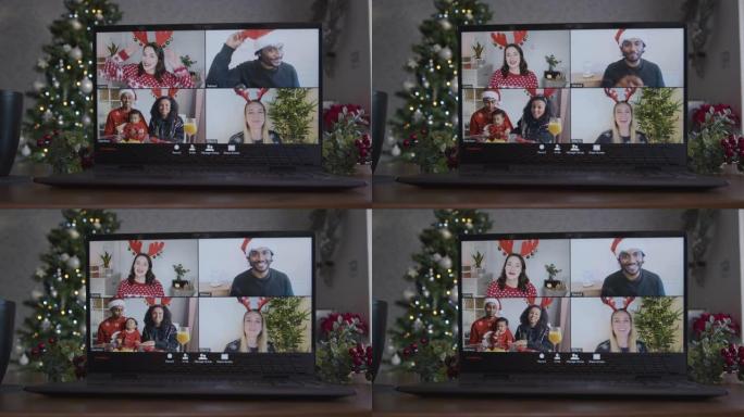 在朋友之间在笔记本电脑上滑动4向分屏圣诞主题视频通话的特写镜头