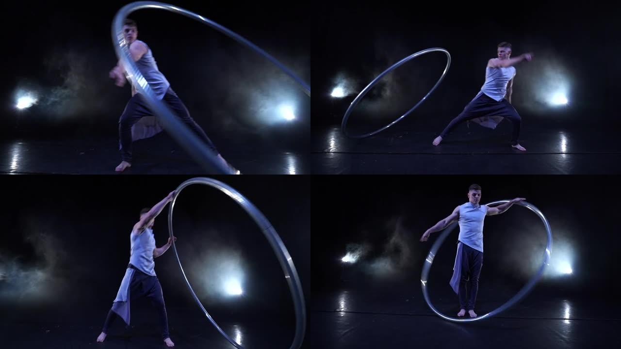 马戏团艺术家与cyr wheel共舞。专注、意志力和运动的概念