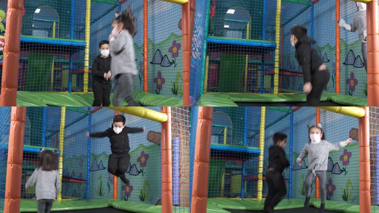 在儿童娱乐中心，戴着口罩的儿童在蹦床上跳跃。