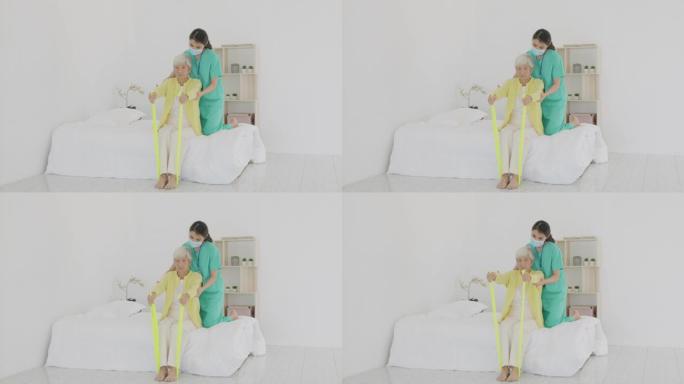手臂关节炎的亚洲高级女性在家里的卧室接受专业护士或家庭健康助手的关节炎物理疗法调色乐队康复。