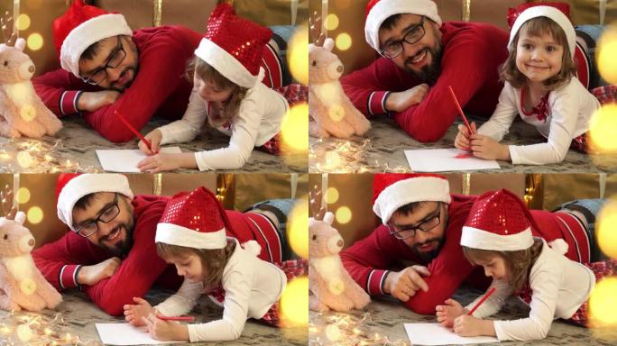 年轻父亲和戴着红色圣诞老人帽子的小女孩的肖像给圣诞老人写信给盒子的圣诞节背景。幸福的家庭庆祝圣诞节和