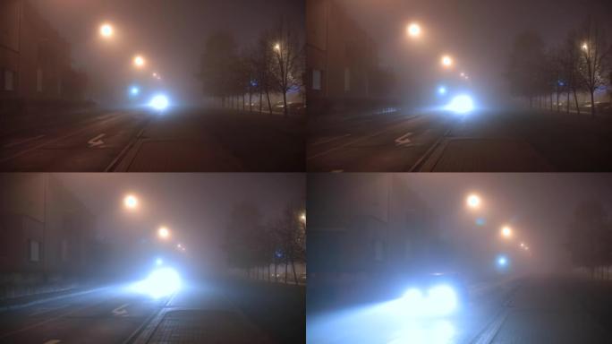 前灯照亮车辆的路径。雾蒙蒙的夜晚。