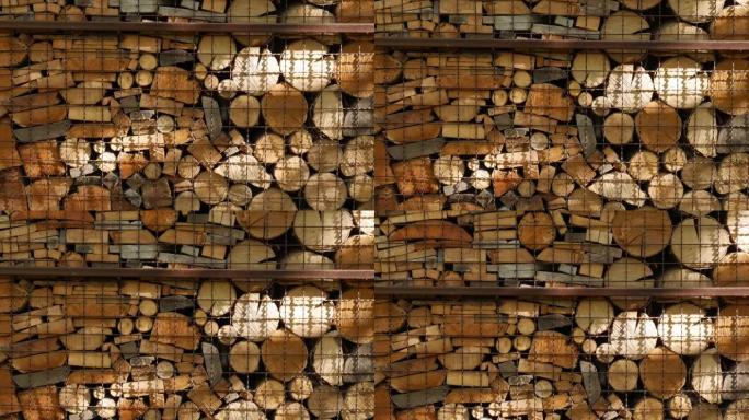 在金属炉排特写后面用天然木材制成的原木和木板。