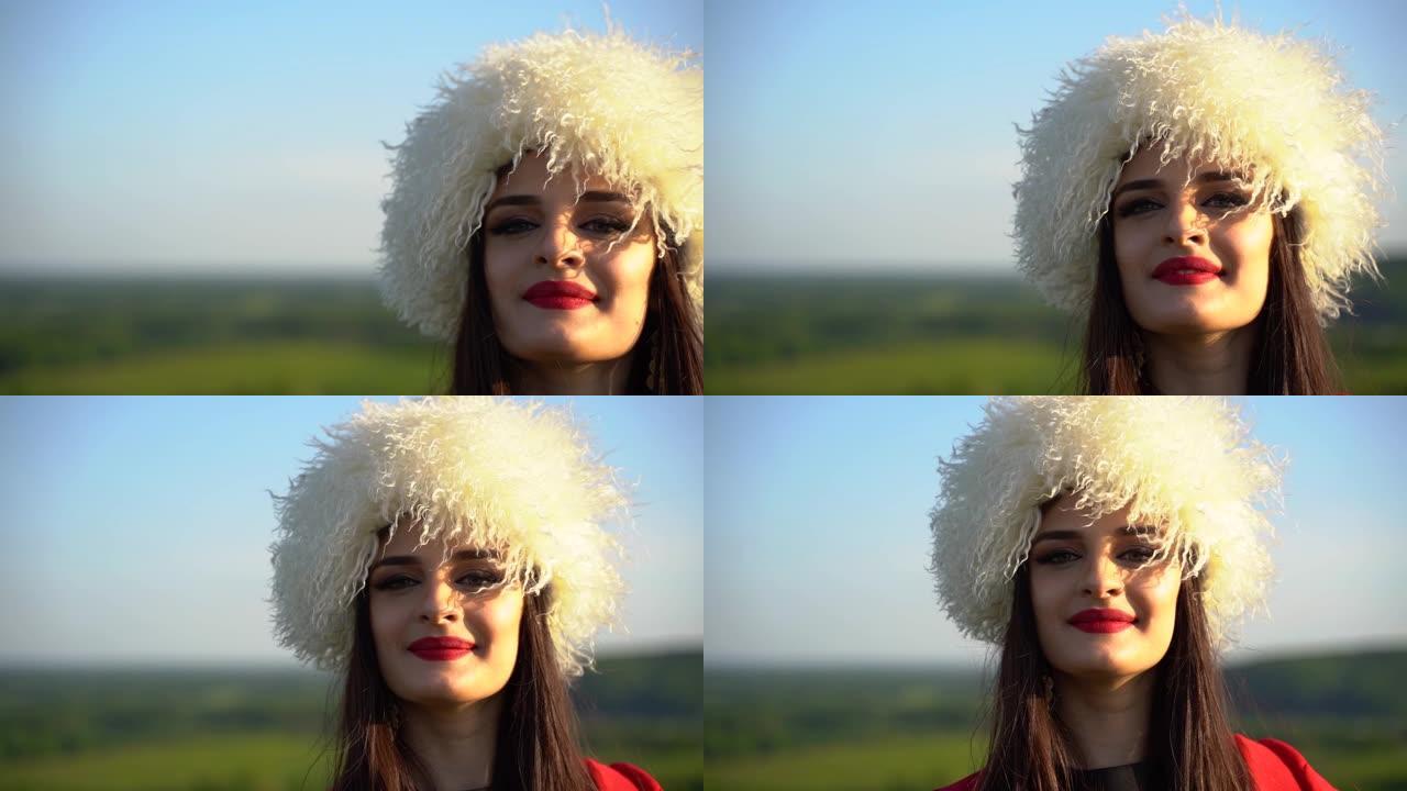 穿着白色木瓜和红色民族服装的格鲁吉亚女孩在绿色的田野上行走和微笑。视频肖像。格鲁吉亚文化生活方式。