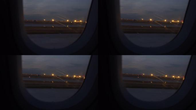 飞机在机场起飞夜晚灯光飞机窗户